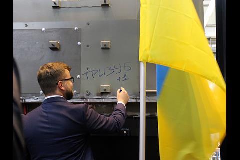 Acting Chairman of the UZ management board Yevgen Kravtsov adds the name ‘Tryzub’ (trident) to the first of the TE33A locomotives (Photo: David Lustig).